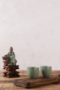 Man sitting on table against wall