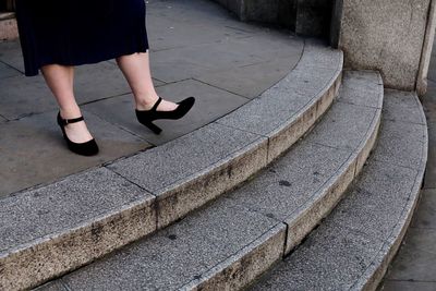 Low section of woman standing on staircase