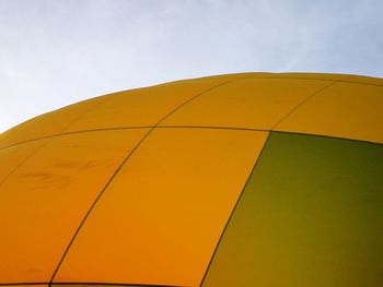 Low angle view of yellow hot air balloon against sky