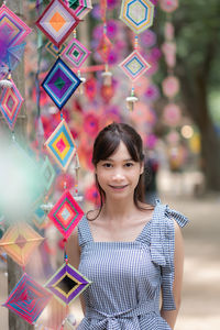 Portrait of smiling young woman standing at beach