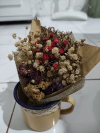 High angle view of flower bouquet in cup on floor