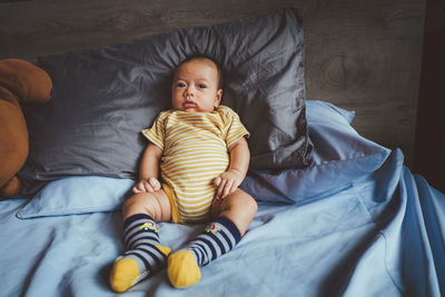 High angle view of baby lying on bed at home