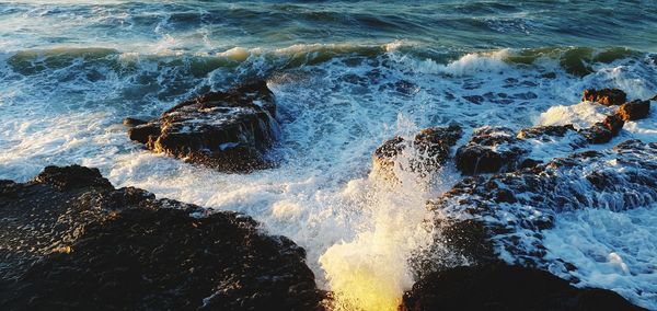 Waves splashing on rocks at shore