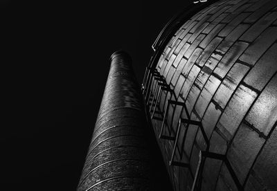 Low angle view of smoke stack against clear sky