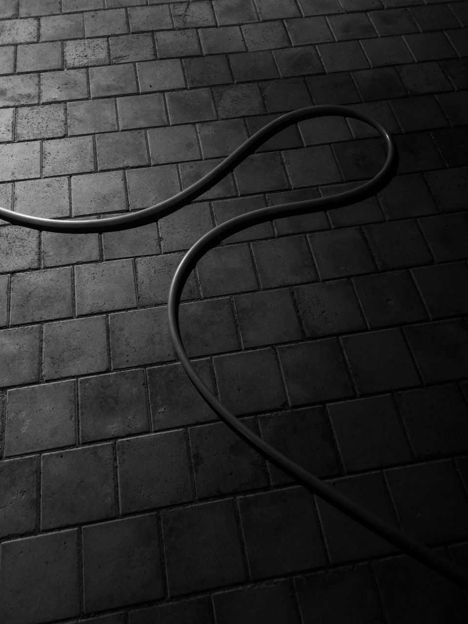 HIGH ANGLE VIEW OF BICYCLE ON COBBLESTONE STREET