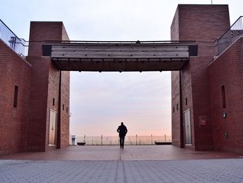 Full length of woman standing in front of building