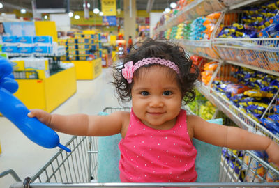 Cute girl in shopping cart