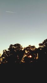 Low angle view of silhouette trees against sky during sunset