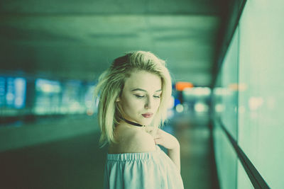 Young woman standing at subway station