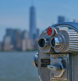 Close-up of coin-operated binoculars against sky