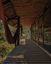 Rear view of person walking on wooden steps leading towards building