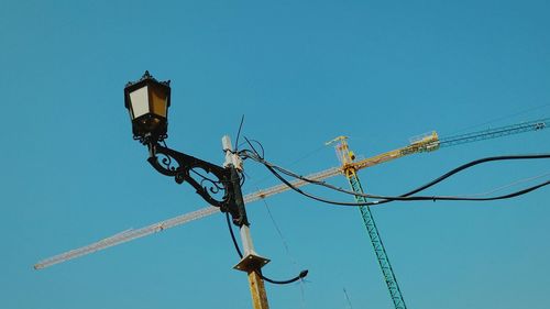 Low angle view of lamp post against clear blue sky