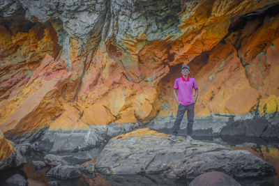 Full length of man standing on rock