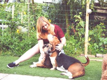 Blond woman with dogs in back yard