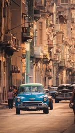 Cars on street by buildings in city