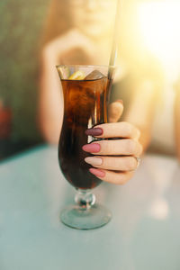 Close-up of hand holding wine glass