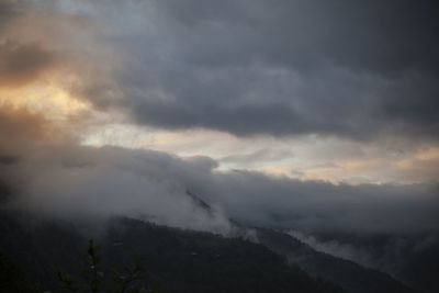 Scenic view of mountain against dramatic sky