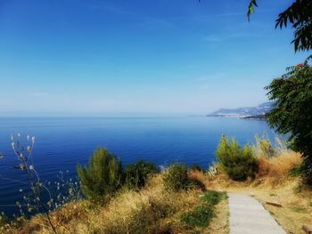 Scenic view of sea against blue sky
