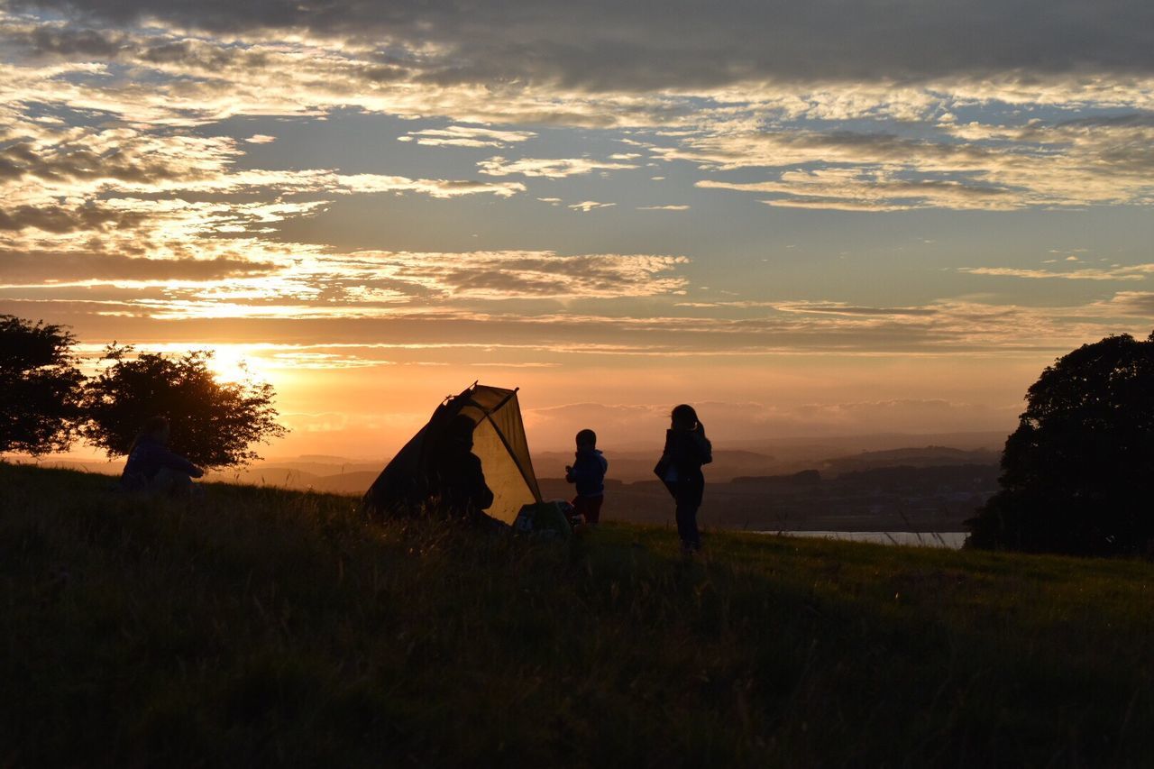 sunset, sky, silhouette, nature, cloud - sky, togetherness, two people, beauty in nature, real people, scenics, men, sitting, outdoors, grass, friendship, women, tree, day, people