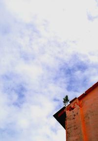 Low angle view of built structure against cloudy sky