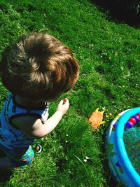 High angle view of boy on grassy field