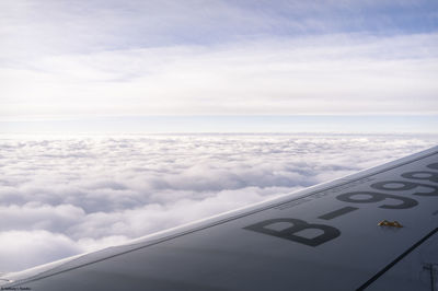 Aerial view of airplane wing against sky