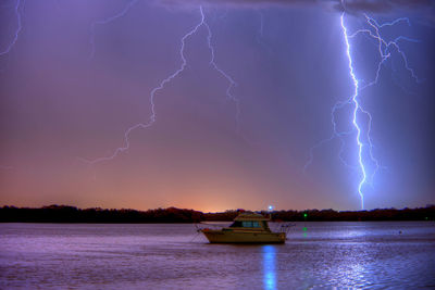 Lightning over sea against sky