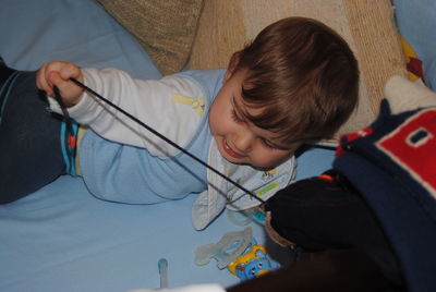 High angle view of cute boy holding camera at home