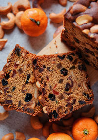 Sliced fruit cake with cashew nuts and oranges