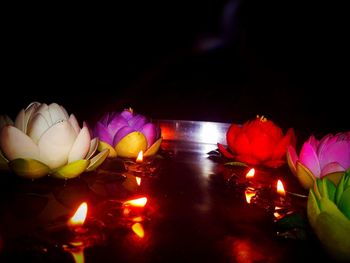 Close-up of multi colored illuminated lights on black background