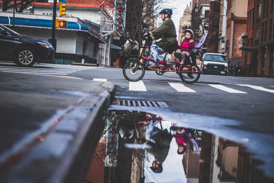 People riding bicycle on city street