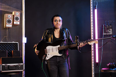 Portrait of young man playing guitar