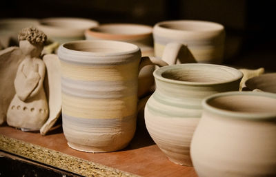 Ceramic clay products stand on the shelf close-up, macro