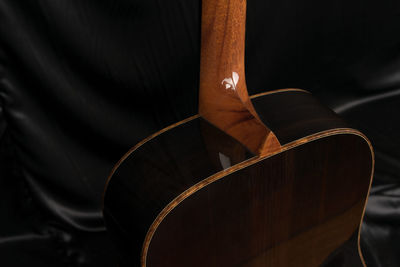 Close-up of guitar on bed