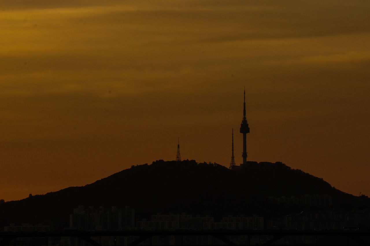 sunset, building exterior, architecture, built structure, silhouette, sky, mountain, communications tower, tower, orange color, religion, scenics, dusk, spire, spirituality, travel destinations, lighthouse, beauty in nature, place of worship, famous place