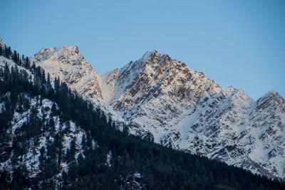 Scenic view of snowcapped mountains against clear sky