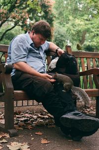 Man sitting on bench in park