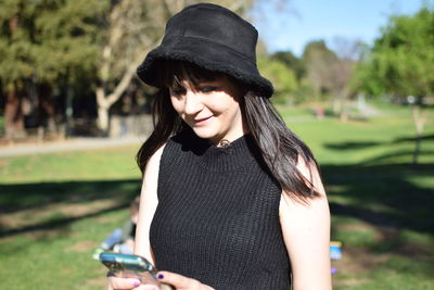 Portrait of a smiling young woman standing outdoors