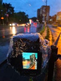 Close-up of illuminated lighting equipment on street at night