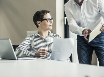 Businesswoman and businessman working in conference room