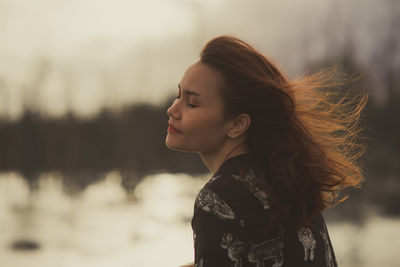 Portrait of woman looking away outdoors