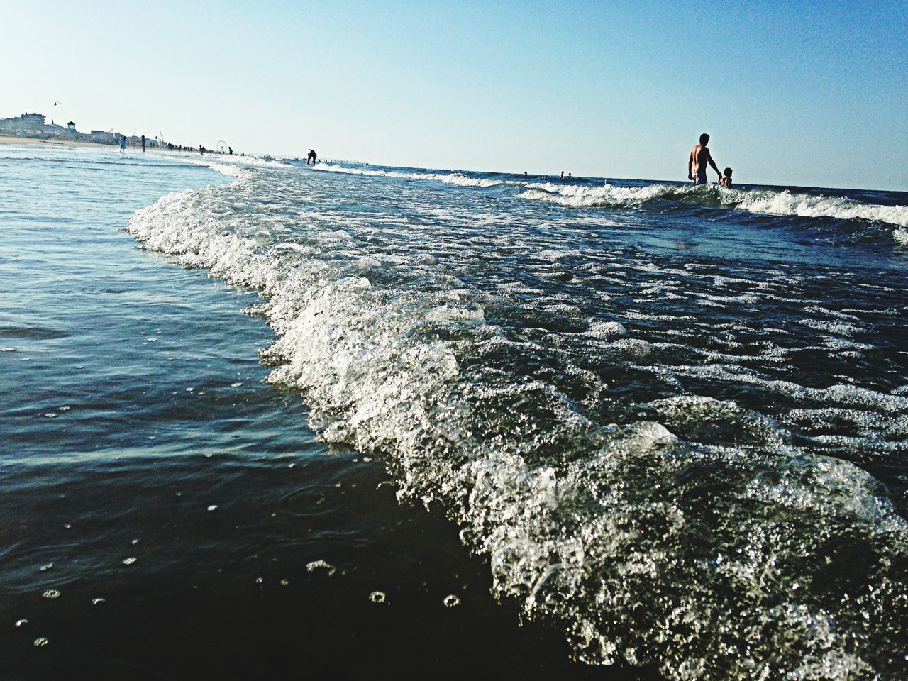 sea, water, horizon over water, beach, clear sky, leisure activity, tranquil scene, scenics, shore, tranquility, men, lifestyles, beauty in nature, nature, vacations, wave, copy space, tourist, incidental people