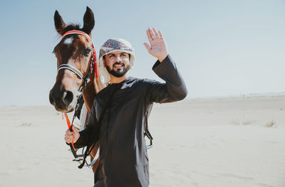 Portrait of man standing on sand