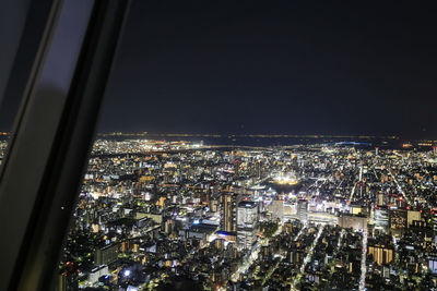 High angle view of illuminated city buildings at night