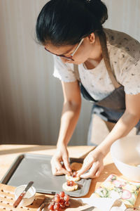 Woman preparing food in kitchen