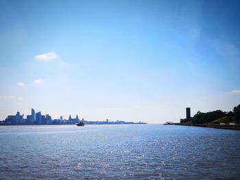 Scenic view of sea and buildings against sky