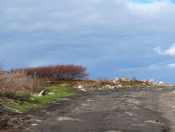 Road by land against sky