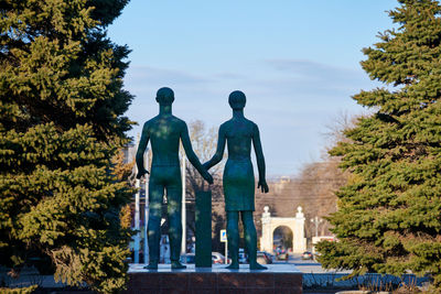 Rear view of man standing against trees