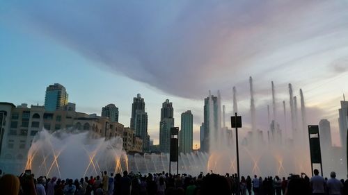 Panoramic view of crowd in city against sky