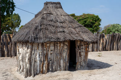 Panoramic view of trees and house on beach against sky